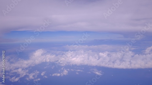 Top view white clouds with blue sky, a view from plane window 