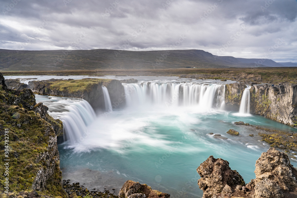 Godafoss waterfall, foggy from waterspray on a cloudy morning, Iceland Godafoss waterfall, foggy from waterspray on a cloudy morning, Iceland