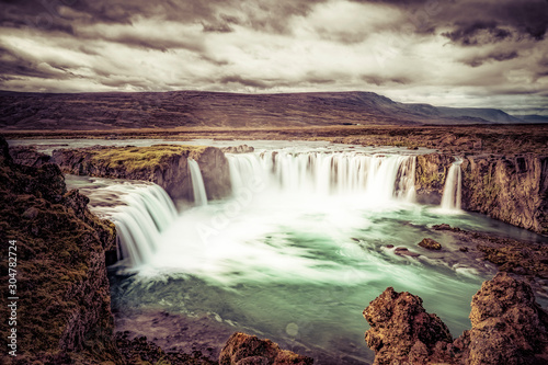 Godafoss waterfall  foggy from waterspray on a cloudy morning  Iceland