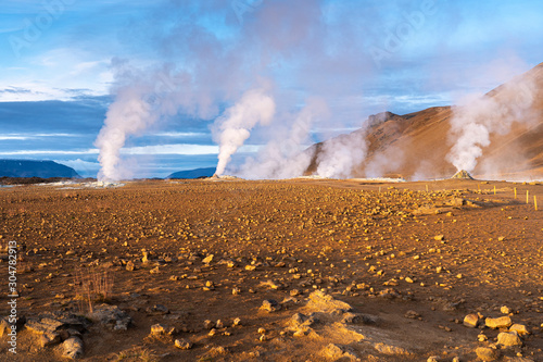 steaming mud holes and solfataras in the geothermal area of Hverir near lake Myvatn, northern Iceland photo