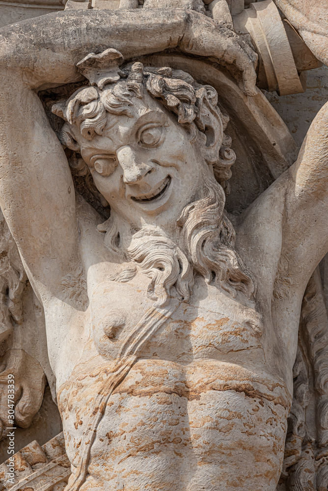 Old sculpture of funny and joyful dickens in downtown of Dresden, Germany, details, closeup Old sculpture of funny and joyful dickens in downtown of Dresden, Germany, details, closeup