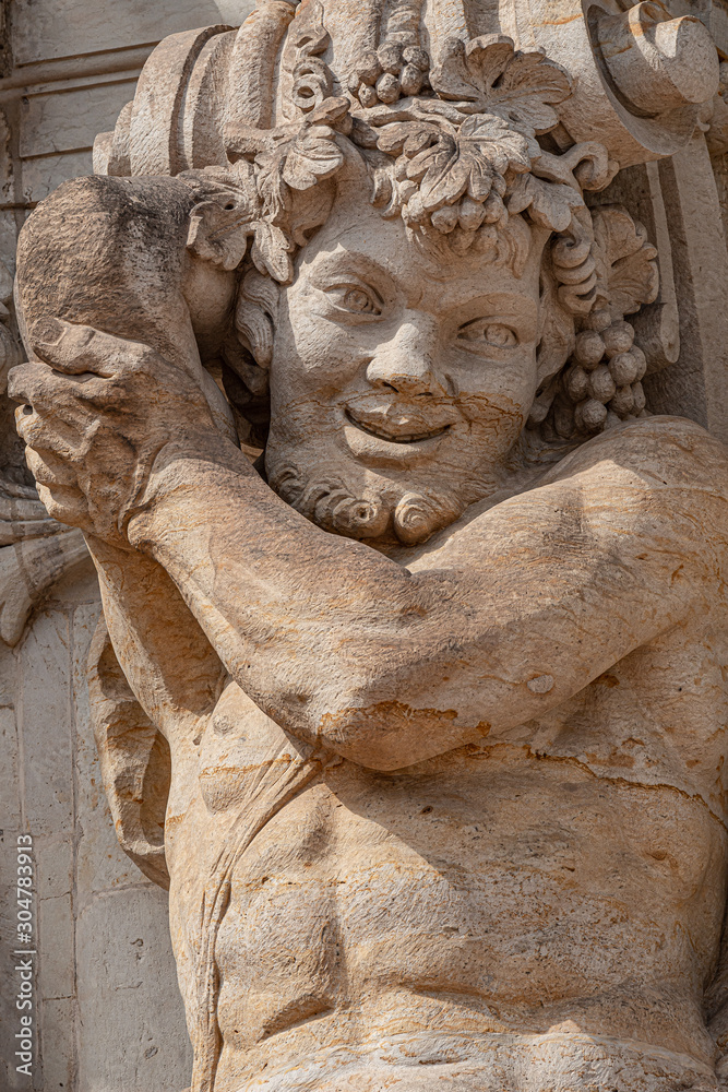 Old sculpture of funny and joyful dickens in downtown of Dresden, Germany, details, closeup
