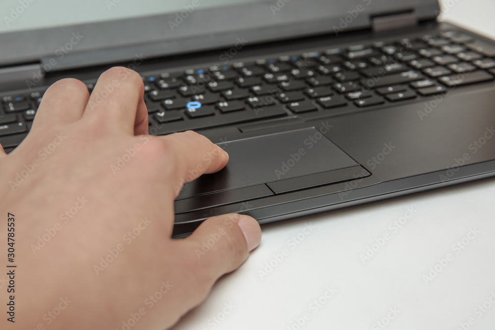 Hand on touch pad of laptop makes manipulations Hand on touch pad of laptop makes manipulations