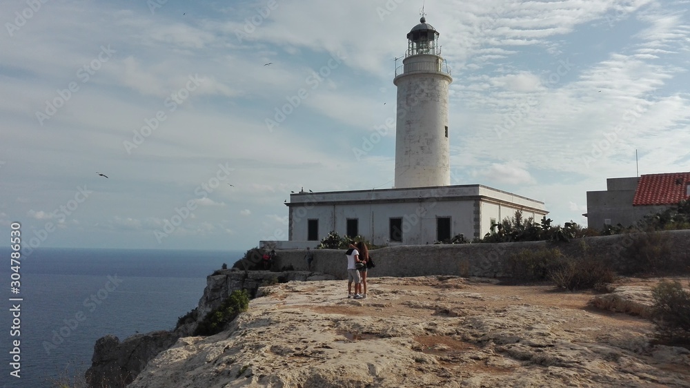 Fototapeta premium the beautiful lighthouse on the cliff overlooking the island of Formentera in the Balearic Islands