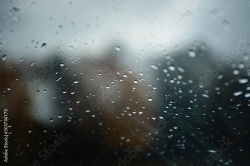 Raindrops on the windshield of a small yacht. Beautiful drops on the window on a rainy autumn day