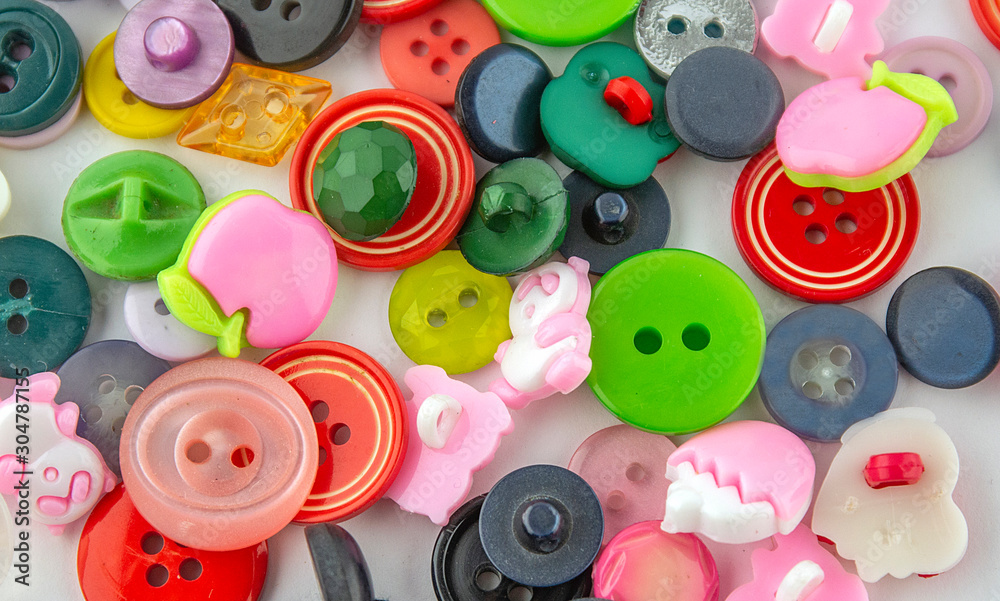 Colorful buttons on a white background. Top view.