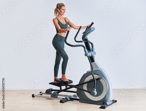 Woman exercising at the gym on crosstrainer