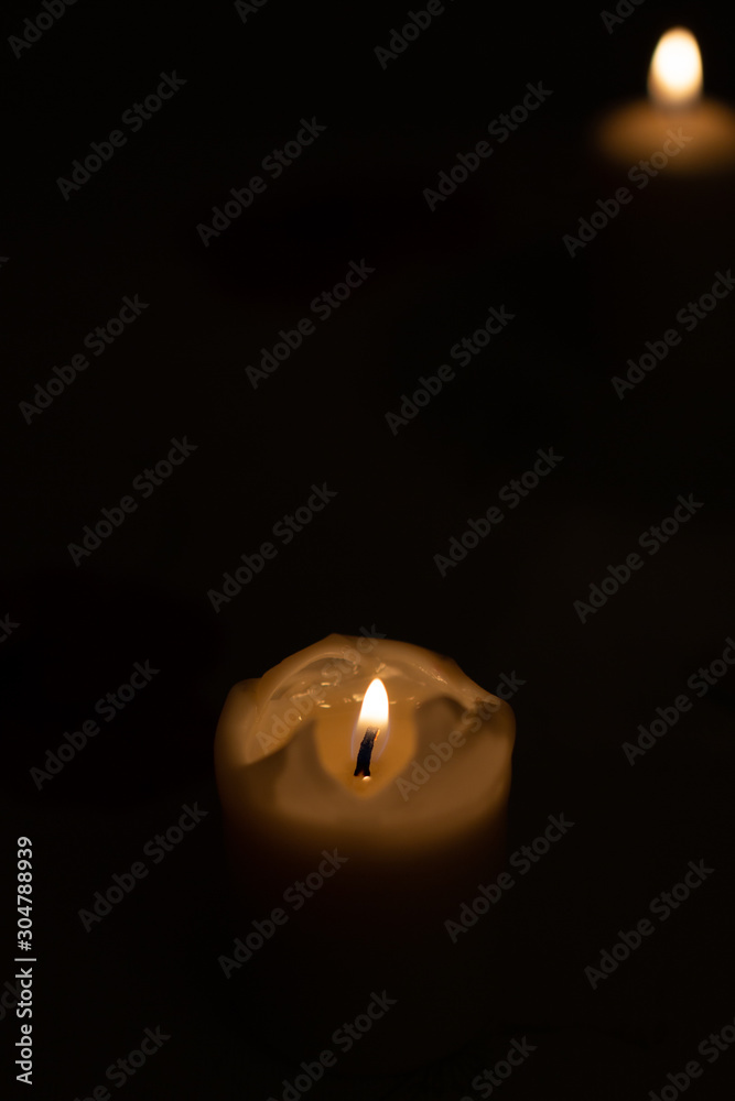 Candle on black background. Candle lighting in the room. Candle on black background. Candle lighting in the room.