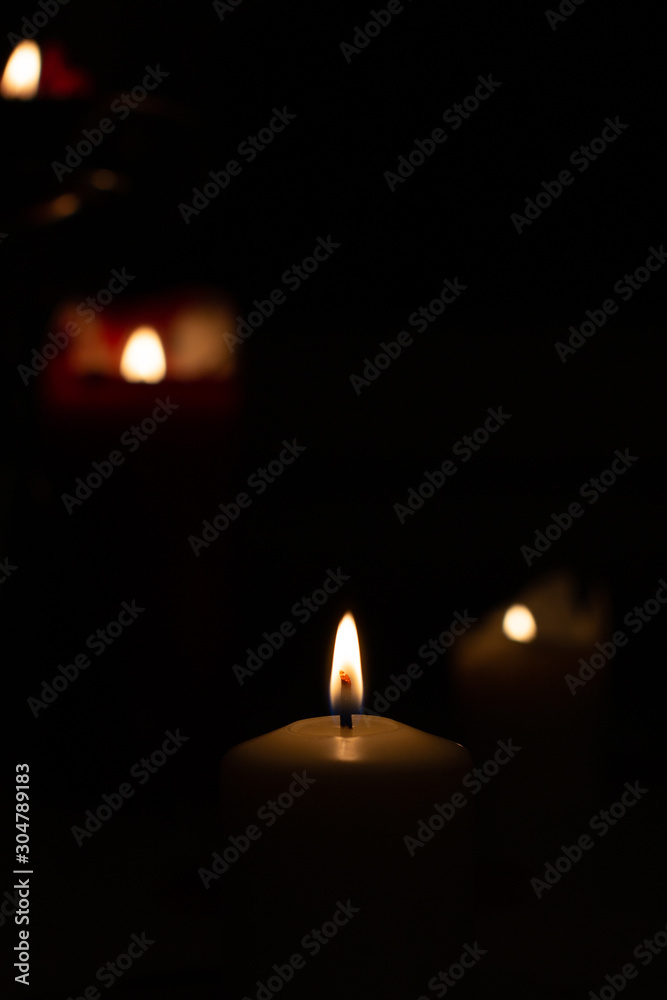 Candle on black background. Candle lighting in the room.