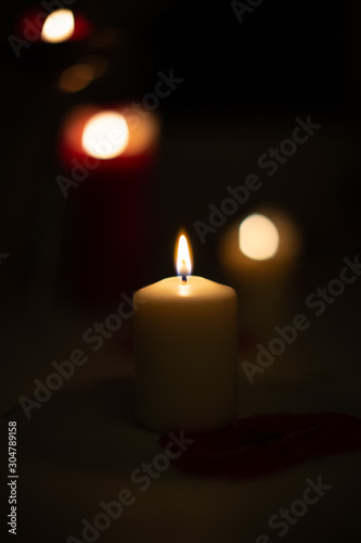 Candle on black background. Candle lighting in the room.