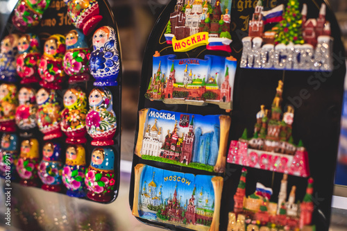 View of traditional souvenirs from Moscow, Russia, with fridge magnets with "Moscow" text, Kremlin and St. Basil Cathedral figure at local vendor souvenir shop on Red Square