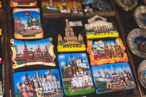 View of traditional souvenirs from Moscow, Russia, with fridge magnets with "Moscow" text, Kremlin and St. Basil Cathedral figure at local vendor souvenir shop on Red Square © tsuguliev