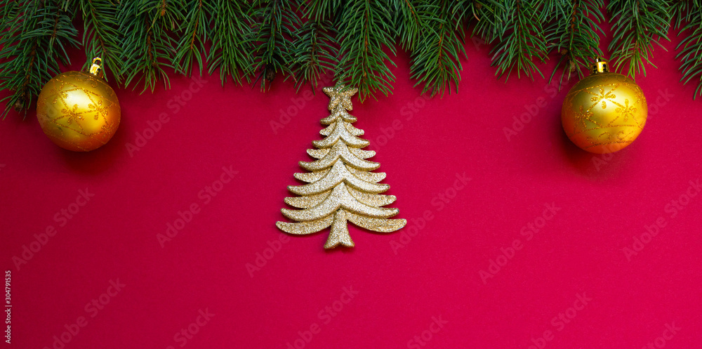 Christmas border. Fir branches and ornament on red background with copy space for your text. Christmas greeting card. Winter xmas holiday theme. Happy New Year. Christmas border. Fir branches and ornament on red background with copy space for your text. Christmas greeting card. Winter xmas holiday theme. Happy New Year.