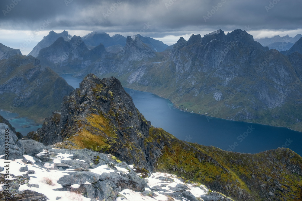 View from the top of Mount Munken to fjord  under a stormy sky at sunset on the Lofoten Islands, Polar, Norway,