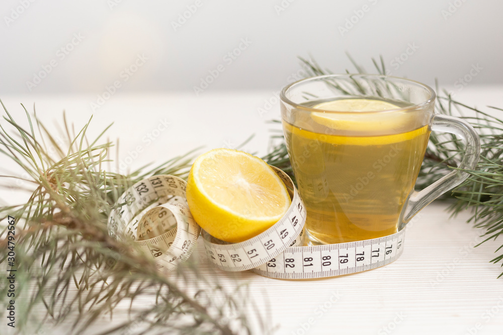Cup of green tea used as a organic way to loose weight. Weight loss concept by natural organic methods. Close-up herbal cup of tea. Cup of green tea used as a organic way to loose weight. Weight loss concept by natural organic methods. Close-up herbal cup of tea.