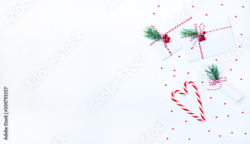 Christmas composition. Christmas gift  decoration  fir branches on light background. Flat lay  top view  copy space