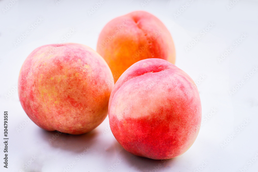Three Pink Peaches Isolated on Light Background Three Pink Peaches Isolated on Light Background