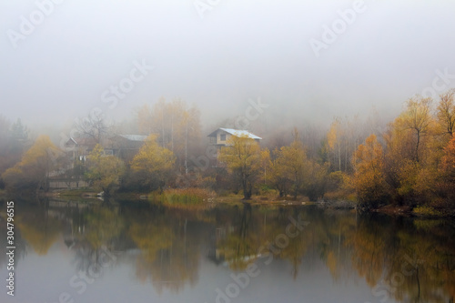 Foggy morning over the mountain lake