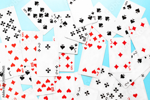 Deck of playing cards on blue background. Top view flat lay