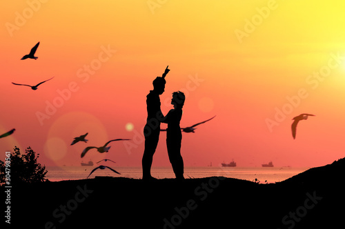 Silhouette couples and sunset light near the sea.