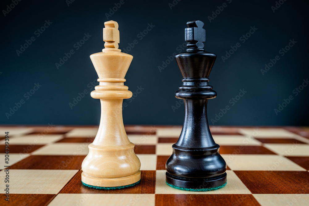 Chess pieces on a chessboard. Symbolic meaning. Beautiful figures on a black background. Chess pieces on a chessboard. Symbolic meaning. Beautiful figures on a black background.