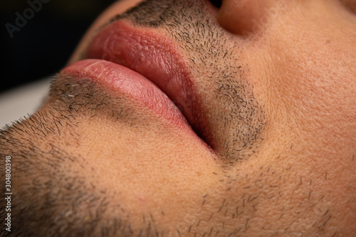 Male NU Lips. Young man closeup lips, male permanent make up, men's bristle.