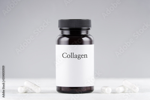 Принти на полотні nutritional supplement collagen bottle and capsules on gray