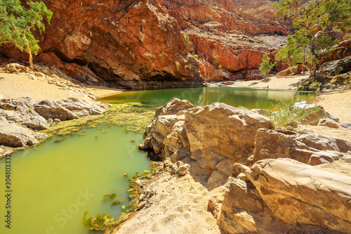 Details of a pond in West MacDonnell Ranges National Park, Northern Territory, Australia. Ormiston Gorge Waterhole with rocky landscape of Australian Outback.