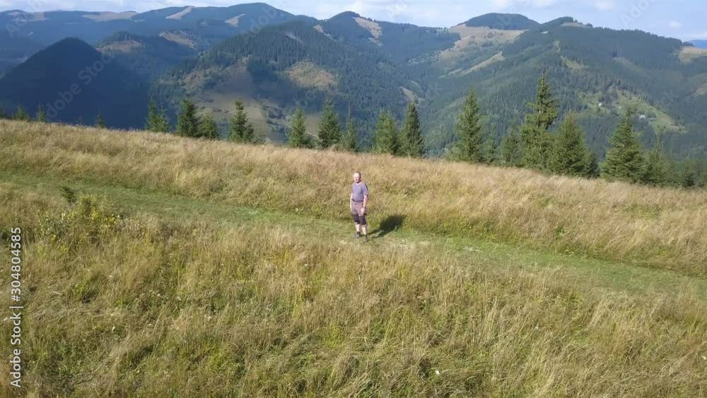4K .Aerial travel team. Fly around adult man tourist on ridge in autumn mountain area. 4K .Aerial travel team. Fly around adult man tourist on ridge in autumn mountain area.