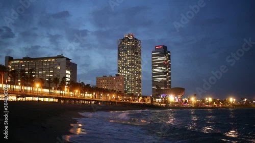 BARCELONA, SPAIN - JUNE 13, 2019:  view of Barceloneta beach with Mapfre tower and Arts Hotel in Barcelona in night photo