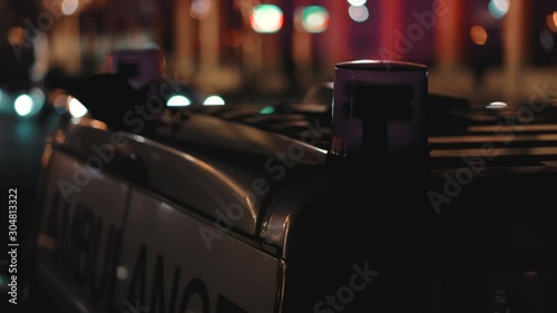 Ambulance with flashing lights on a city street at night. Close-up. Call a doctor. Crime scene ambulance