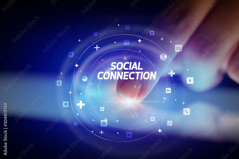 Finger touching tablet with social media icons and SOCIAL CONNECTION