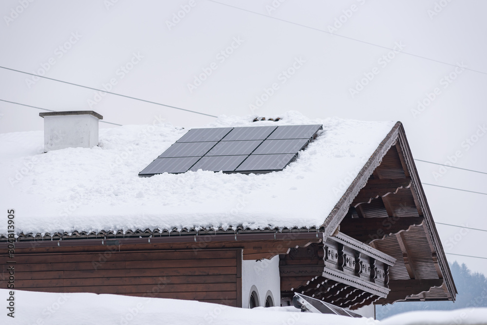 Solar panel, photovoltaic, PV panels on a house roof. Electricity from the sun. House in the mountains.