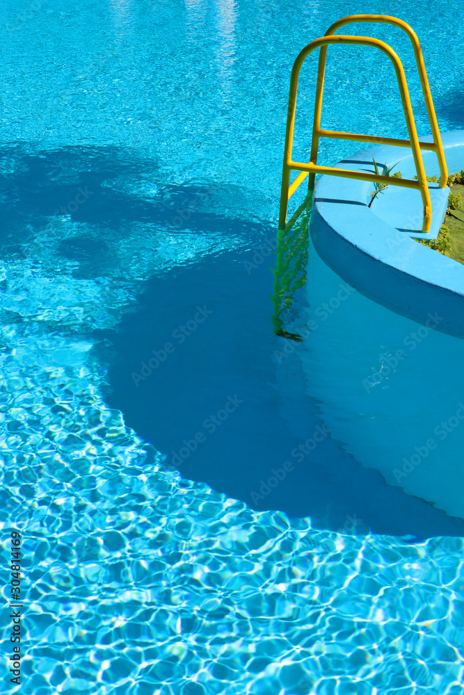 metal ladder of the pool with water metal ladder of the pool with water