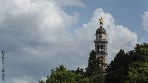Timelapse of the bell tower with angel statue at Castle of Udine and clouds running in background
