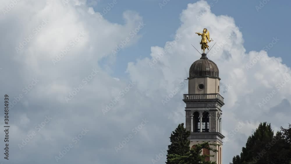 Timelapse of the bell tower with angel statue at Castle of Udine and clouds running in background Timelapse of the bell tower with angel statue at Castle of Udine and clouds running in background