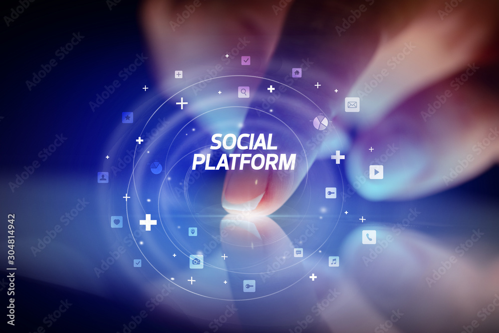 Finger touching tablet with social media icons and SOCIAL PLATFORM