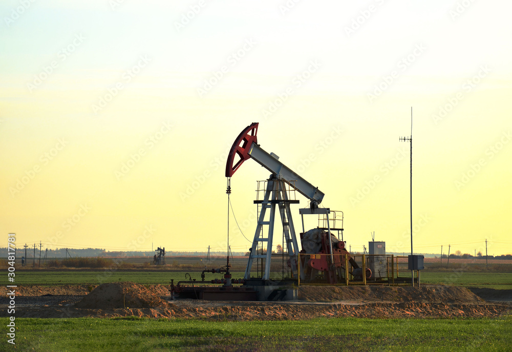 Oil drilling derricks at desert oilfield for fossil fuels output and crude oil production from the ground. Oil drill rig and pump jack. Oil drilling derricks at desert oilfield for fossil fuels output and crude oil production from the ground. Oil drill rig and pump jack.