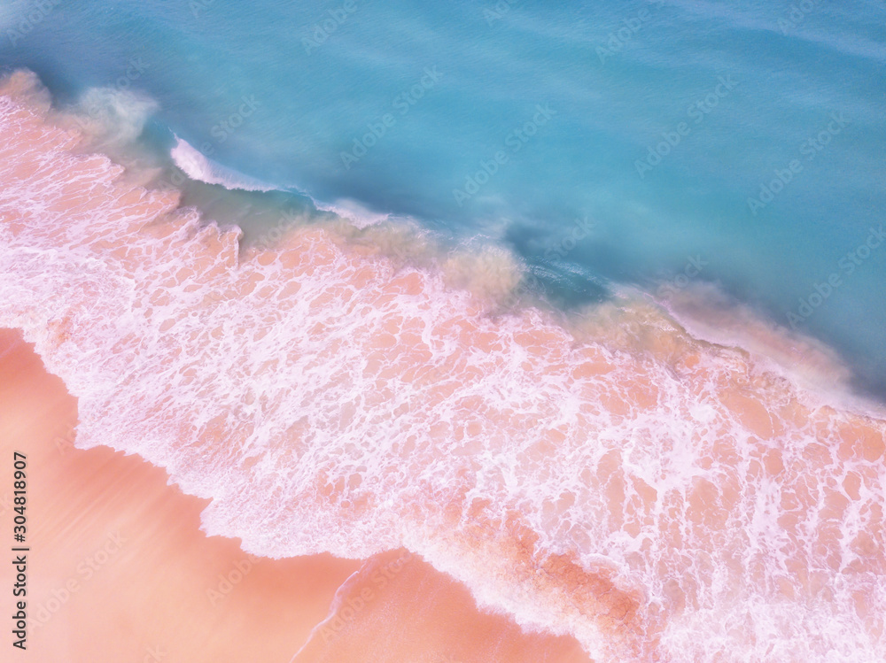 Fototapeta premium Aerial View Of Ocean Waves And Beautiful Pink Sandy Beach Shore - travel concept