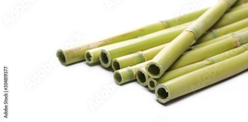Green bamboo sticks isolated on white background  side view