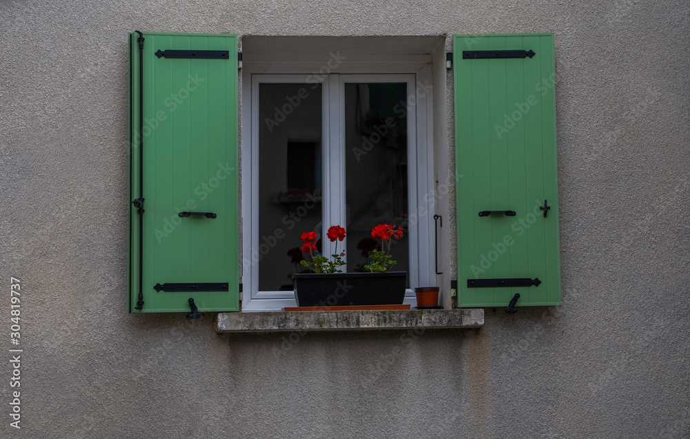 Old building in France. Wall with windows and shutters. Building with beautiful old architecture. Old window on old wall.