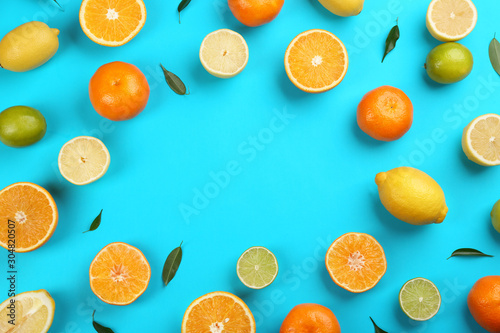 Flat lay composition with tangerines and different citrus fruits on blue background. Space for text