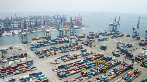 JAKARTA, Indonesia - November 19, 2019: Aerial landscape of containers in Tanjung Priok industrial port. Shot in 4k resolution from a drone flying forwards photo