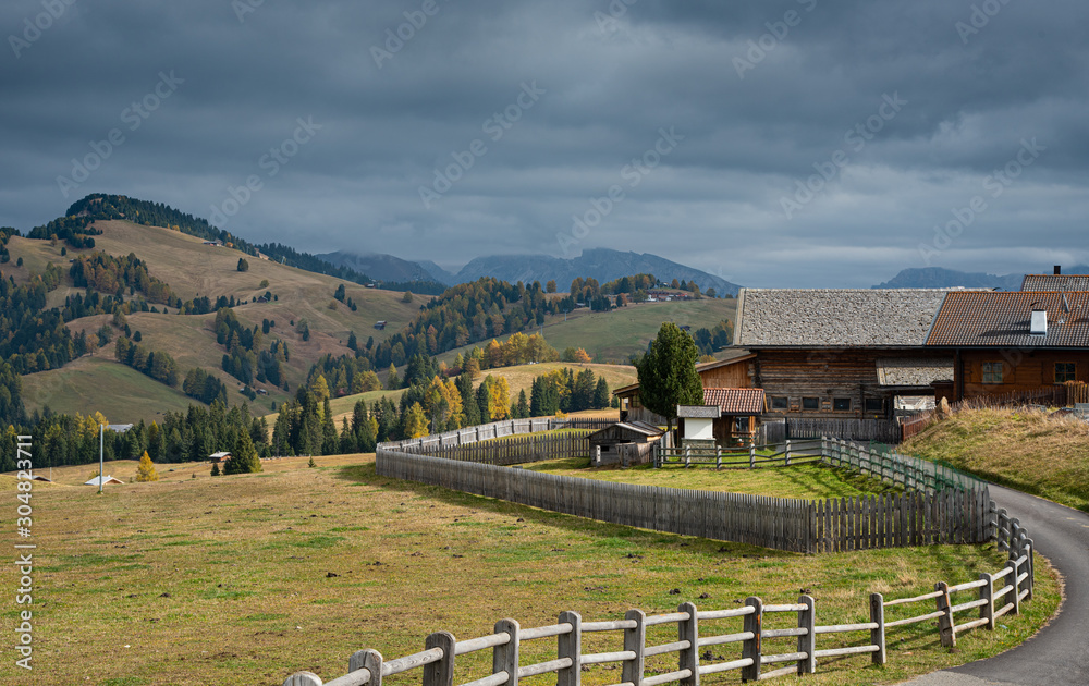 Wooden chalet at the famous Alpe di Siusi valley on the Dolomites, South Tyrol in Italy