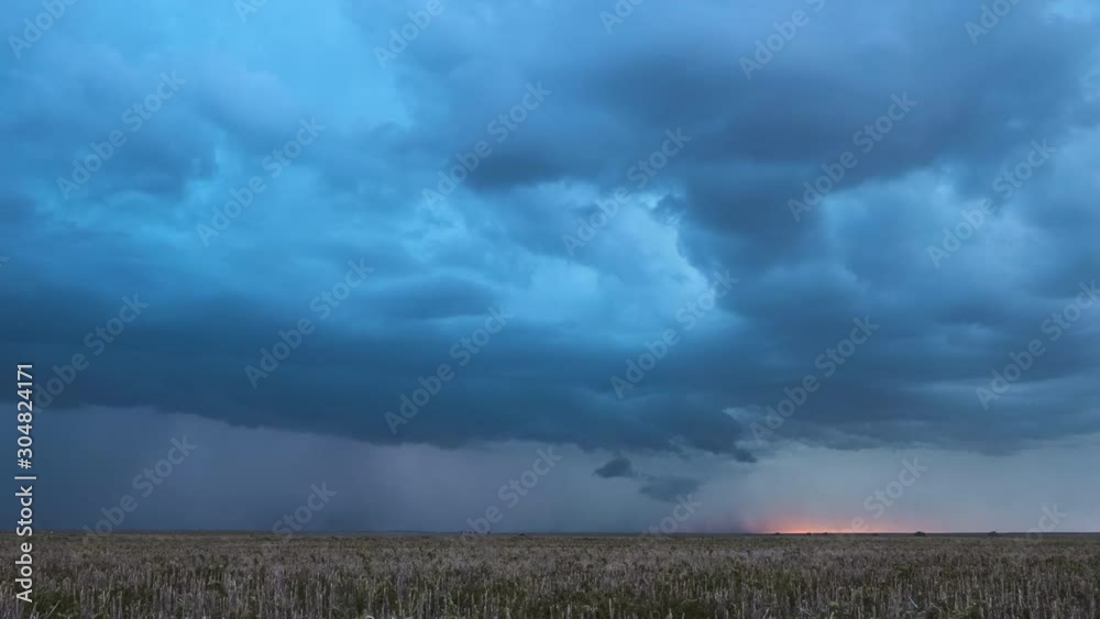 Supercell lightning storm moving over the landscape during the monsoon season.