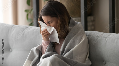 Sick girl blowing nose feeling unwell having flu