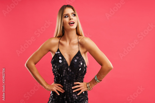 Beautiful adult woman posing over pink background
