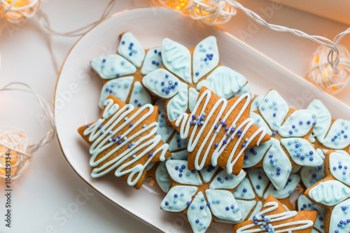 Traditional Estonian handmade decorated star- shaped gingerbread cookies for Christmas (piparkook) on the white plate