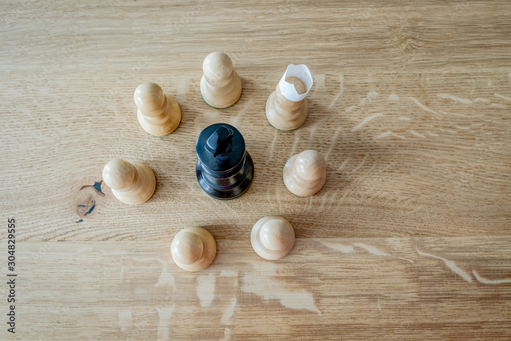 Chess pieces on a wooden table. Symbolic meaning. Beautiful figures on an oak wood background.