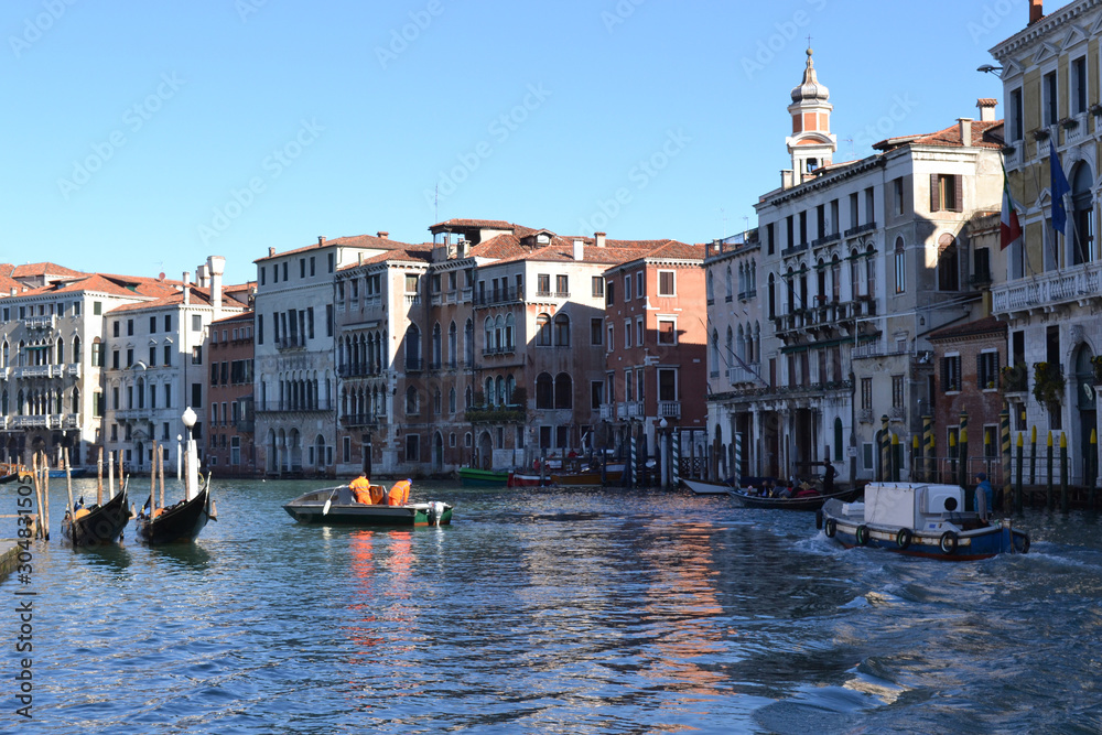 Venice. Grand canal with boats and gondolas. View of the old buildings.